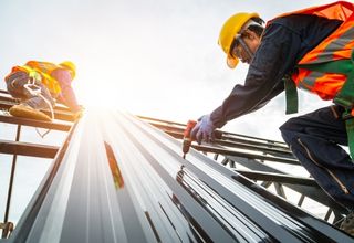 Plant reliability engineers reviewing equipment maintenance tracking spreadsheets